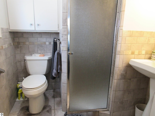 2011 Douglas Dr, Tawas City, MI 48763 - full bathroom with tile walls, a shower stall, and toilet