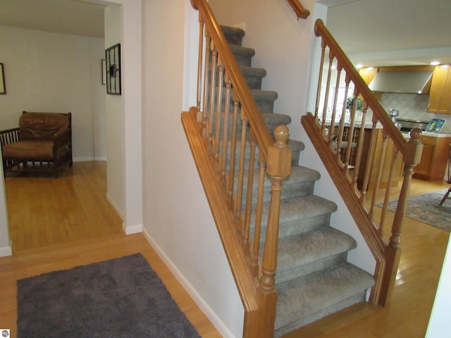 2011 Douglas Dr, Tawas City, MI 48763 - stairs featuring wood finished floors and baseboards