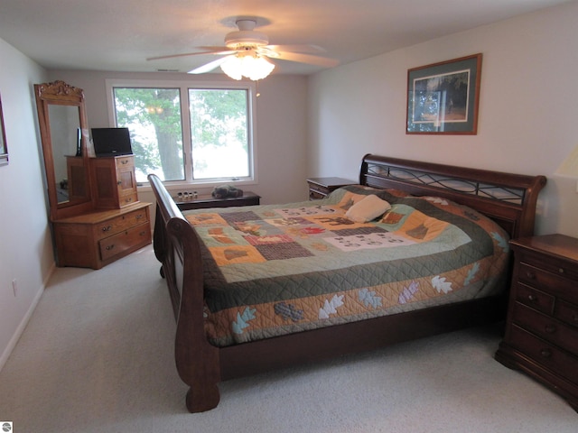 2011 Douglas Dr, Tawas City, MI 48763 - bedroom with light colored carpet and ceiling fan