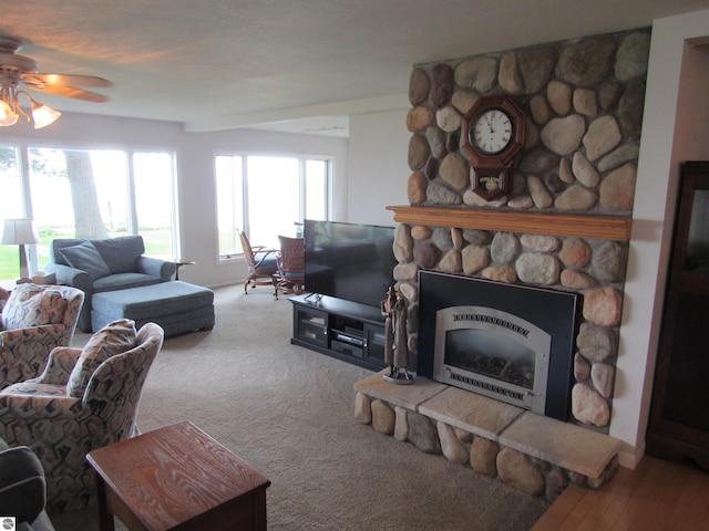 2011 Douglas Dr, Tawas City, MI 48763 - living area with a ceiling fan, a stone fireplace, and heating unit