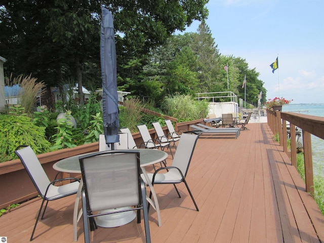 2011 Douglas Dr, Tawas City, MI 48763 - wooden terrace with outdoor dining area