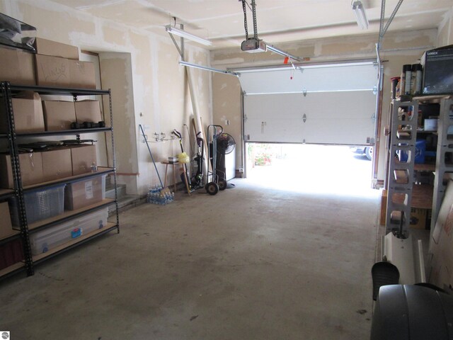 2011 Douglas Dr, Tawas City, MI 48763 - garage featuring a garage door opener