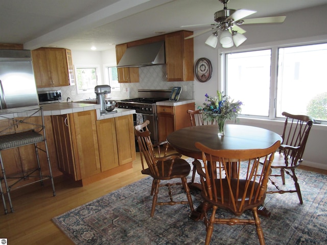 2011 Douglas Dr, Tawas City, MI 48763 - dining area featuring light wood-style flooring and a ceiling fan