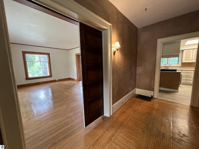 506 E Division St, Cadillac, MI 49601 - spare room with baseboards, light wood-style flooring, and healthy amount of natural light