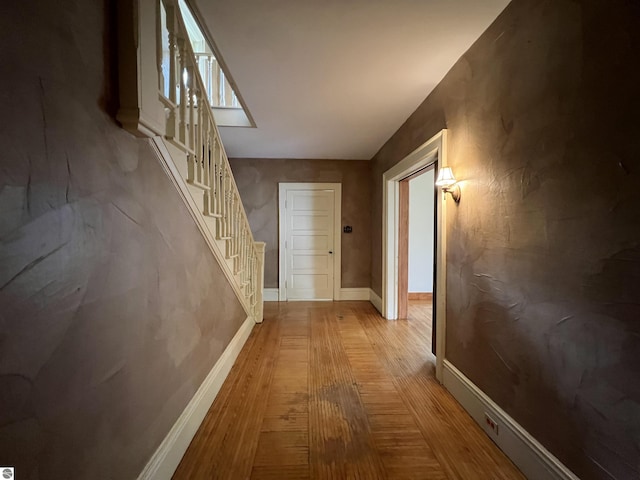 506 E Division St, Cadillac, MI 49601 - hall featuring wood finished floors, stairway, and baseboards