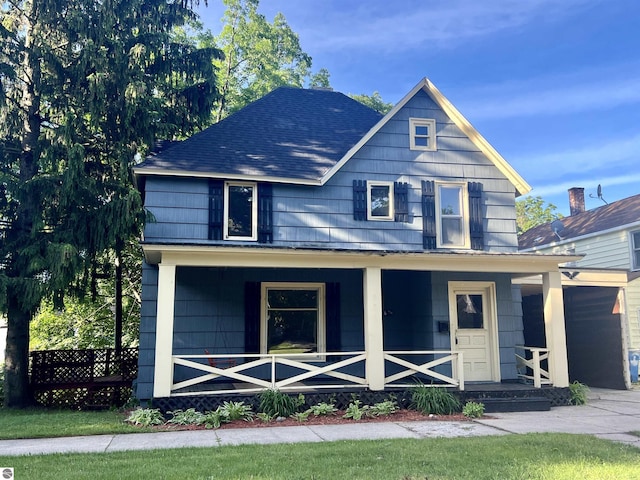 506 E Division St, Cadillac, MI 49601 - view of front facade featuring covered porch and roof with shingles