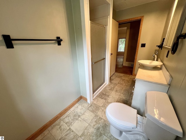 506 E Division St, Cadillac, MI 49601 - bathroom with toilet, baseboards, and a stall shower