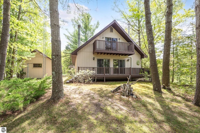3228 S Skeba Rd S, Lake Leelanau, MI 49653 - rear view of property featuring a balcony and a deck