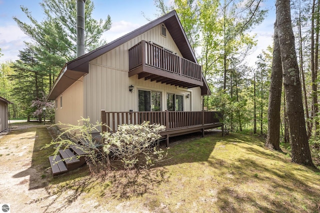 3228 S Skeba Rd S, Lake Leelanau, MI 49653 - view of property exterior featuring a balcony and a deck