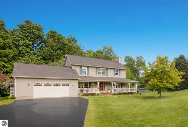 11103 S Ramblewood Dr, Cedar, MI 49621 - view of front of home featuring covered porch, a chimney, driveway, a front yard, and a garage