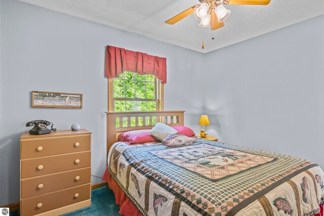 11103 S Ramblewood Dr, Cedar, MI 49621 - bedroom with dark carpet and a ceiling fan