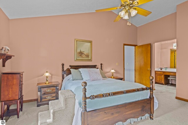 11103 S Ramblewood Dr, Cedar, MI 49621 - bedroom featuring light colored carpet, baseboards, high vaulted ceiling, and ensuite bathroom