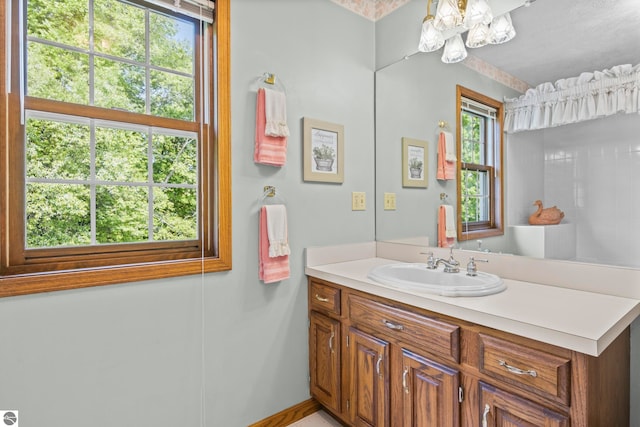 11103 S Ramblewood Dr, Cedar, MI 49621 - bathroom with vanity, baseboards, and a chandelier
