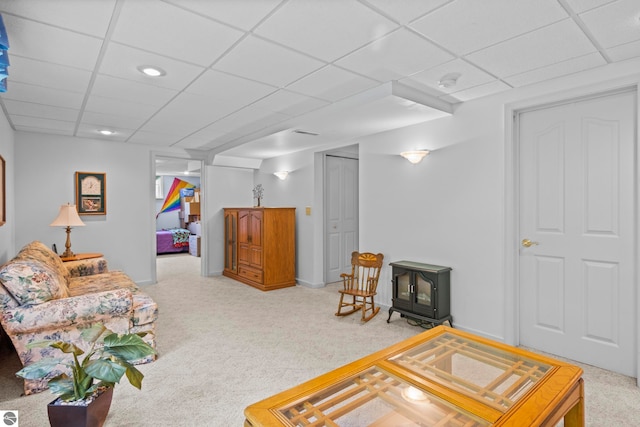 11103 S Ramblewood Dr, Cedar, MI 49621 - living area featuring a wood stove, a drop ceiling, and carpet