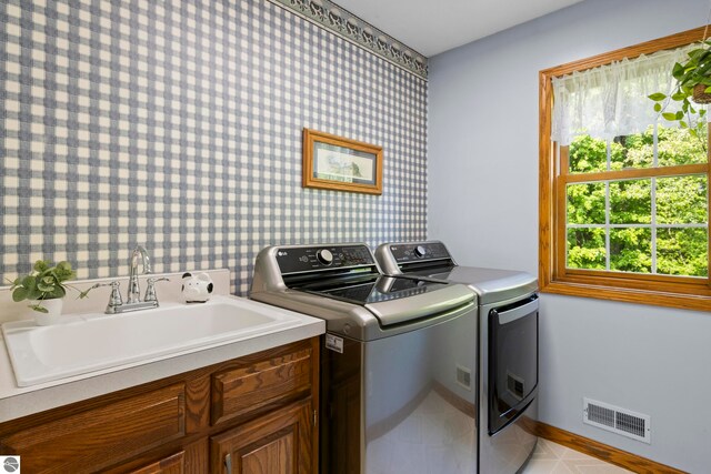 11103 S Ramblewood Dr, Cedar, MI 49621 - laundry area featuring washer and clothes dryer, cabinet space, and baseboards