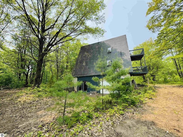 11711 E 22 3/4 Rd, Manton, MI 49663 - view of home's exterior with a wooden deck