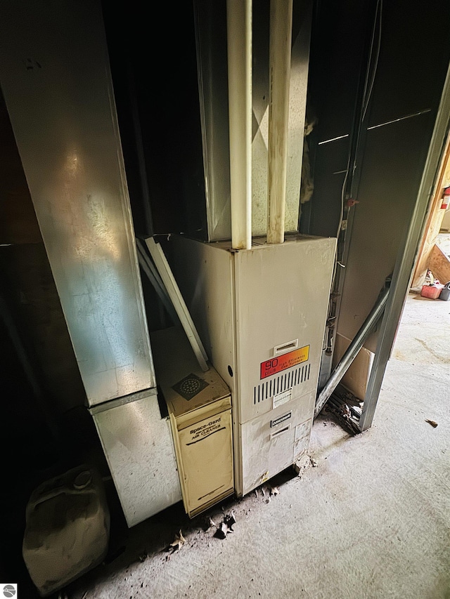 11711 E 22 3/4 Rd, Manton, MI 49663 - utility room with heating unit