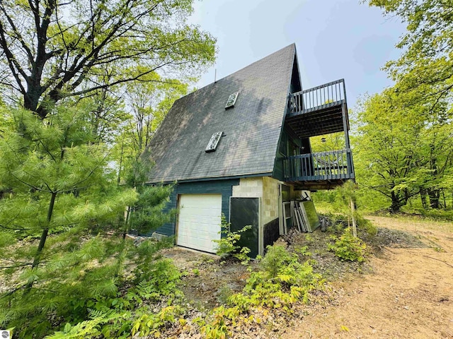 11711 E 22 3/4 Rd, Manton, MI 49663 - view of home's exterior featuring roof with shingles, driveway, and a wooden deck