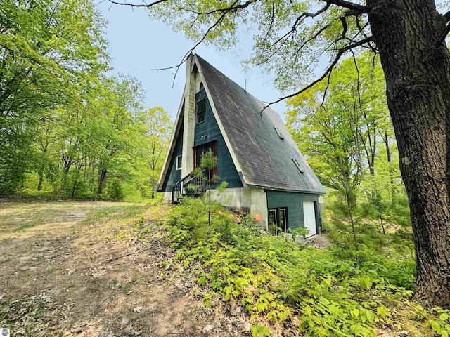 11711 E 22 3/4 Rd, Manton, MI 49663 - view of side of home with a garage
