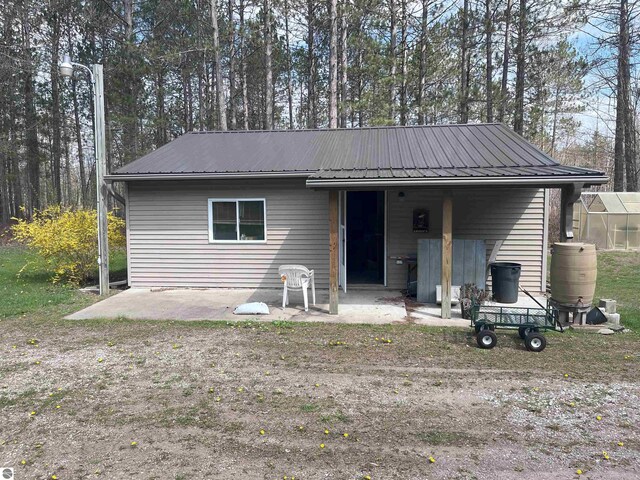 2168 S Lorenz Rd, Tawas City, MI 48763 - view of front of property with metal roof, an exterior structure, and an outdoor structure