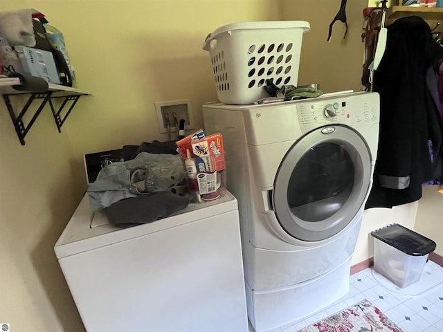 2168 S Lorenz Rd, Tawas City, MI 48763 - laundry area featuring washer and clothes dryer and tile patterned flooring