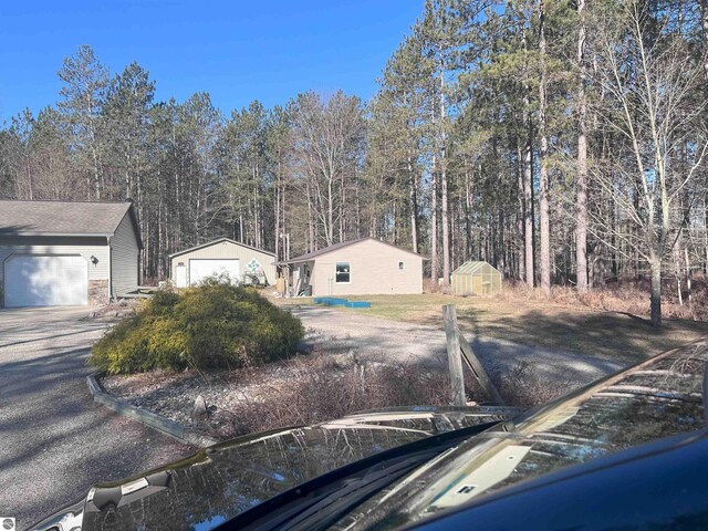 2168 S Lorenz Rd, Tawas City, MI 48763 - view of front of home featuring an outbuilding and a garage