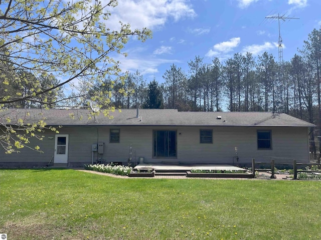2168 S Lorenz Rd, Tawas City, MI 48763 - rear view of property with a yard and a deck