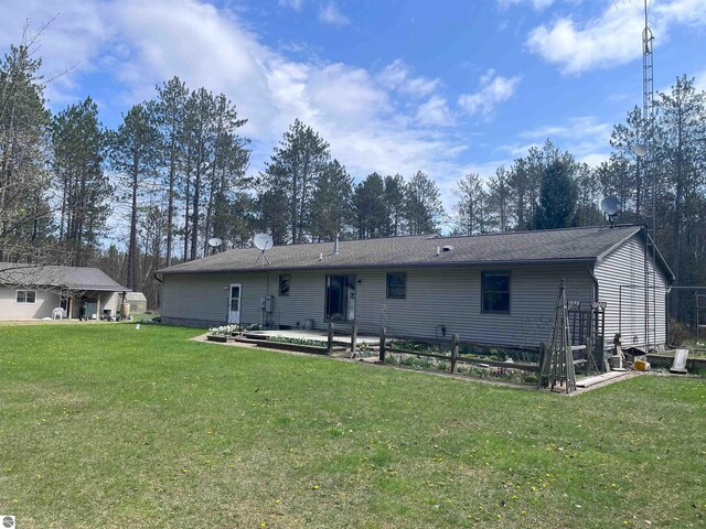 2168 S Lorenz Rd, Tawas City, MI 48763 - back of property featuring a yard