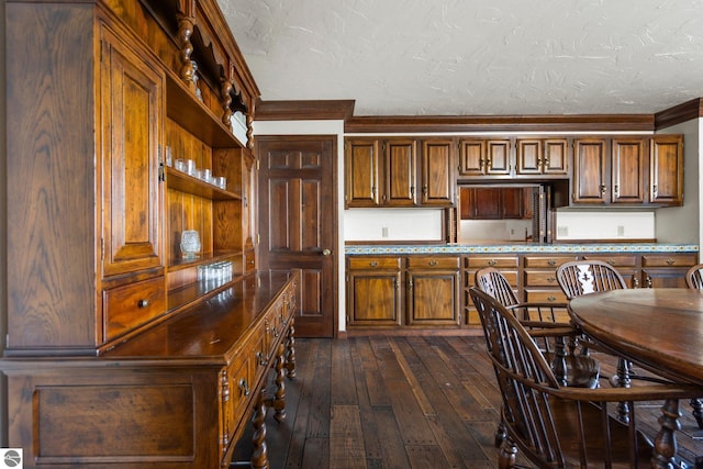 12150 N Seven Pines Rd, Northport, MI 49670 - kitchen featuring crown molding, dark wood finished floors, open shelves, a textured ceiling, and brown cabinets