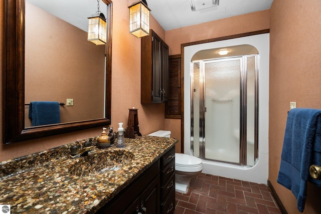 12150 N Seven Pines Rd, Northport, MI 49670 - full bath featuring a stall shower, toilet, vanity, and brick patterned flooring