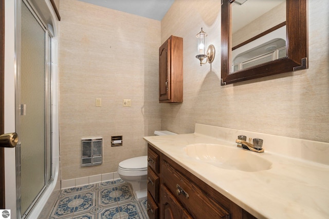 12150 N Seven Pines Rd, Northport, MI 49670 - bathroom with heating unit, an enclosed shower, vanity, toilet, and tile patterned flooring