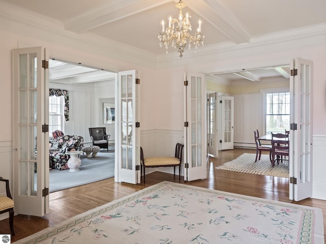 431 Michigan Ave, Charlevoix, MI 49720 - foyer with french doors, beamed ceiling, a decorative wall, wood finished floors, and crown molding