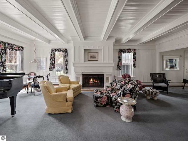 431 Michigan Ave, Charlevoix, MI 49720 - carpeted living area featuring beam ceiling and a large fireplace