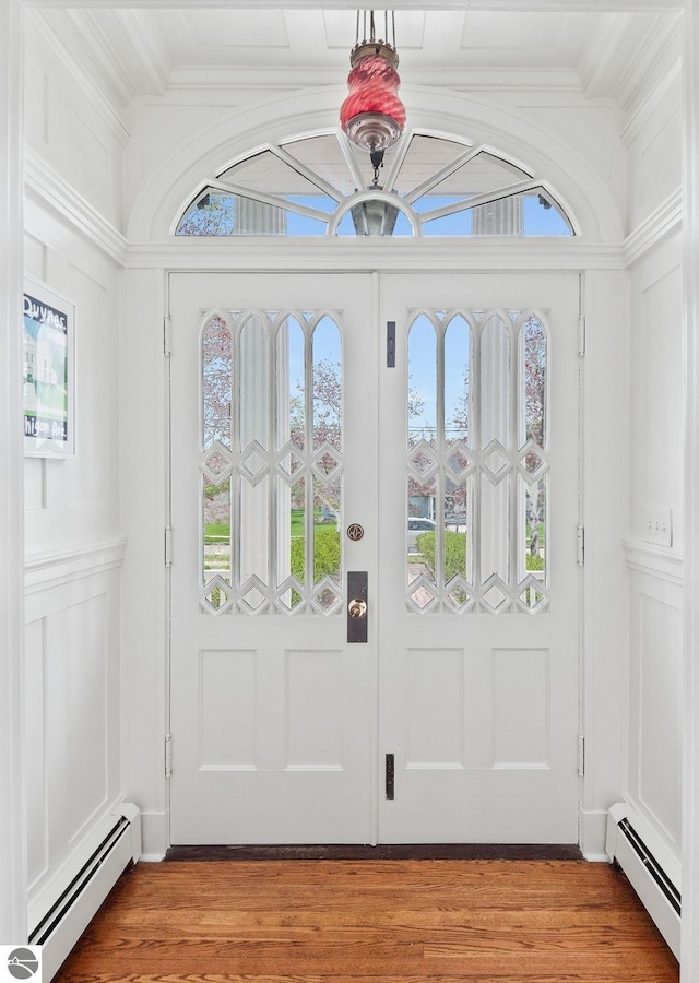 431 Michigan Ave, Charlevoix, MI 49720 - entryway with a baseboard heating unit, crown molding, and light wood-type flooring
