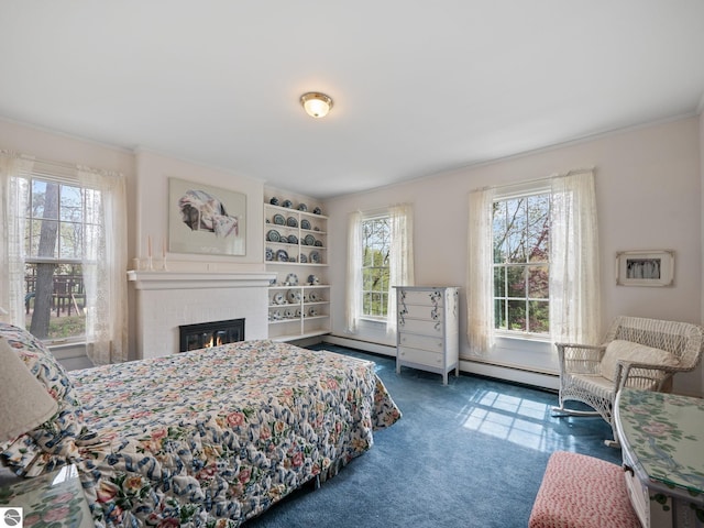 431 Michigan Ave, Charlevoix, MI 49720 - bedroom with ornamental molding, a baseboard heating unit, carpet floors, and a fireplace