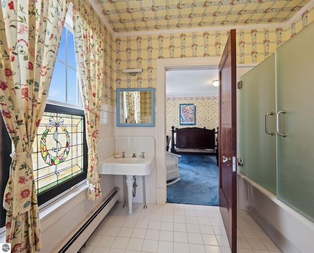 431 Michigan Ave, Charlevoix, MI 49720 - full bathroom featuring wallpapered walls, tile patterned floors, baseboard heating, and bath / shower combo with glass door