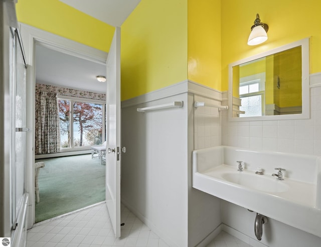 431 Michigan Ave, Charlevoix, MI 49720 - bathroom featuring a wainscoted wall, a baseboard heating unit, and tile patterned floors