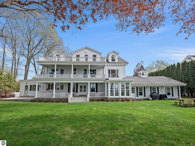 431 Michigan Ave, Charlevoix, MI 49720 - back of house featuring a balcony and a lawn