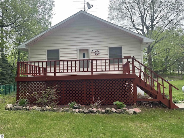 142 Forest Trl, Leroy, MI 49655 - rear view of property with a lawn and a deck