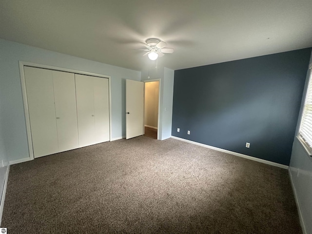 142 Forest Trl, Leroy, MI 49655 - unfurnished bedroom featuring carpet floors, a closet, baseboards, and ceiling fan