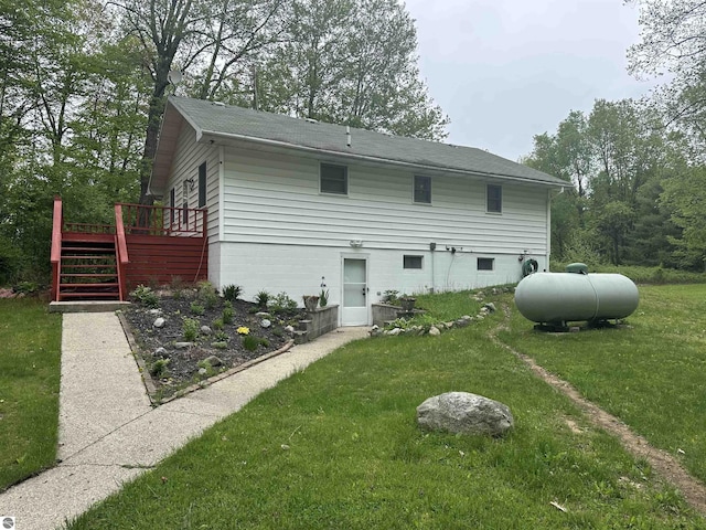 142 Forest Trl, Leroy, MI 49655 - rear view of house with stairs, a yard, and a wooden deck