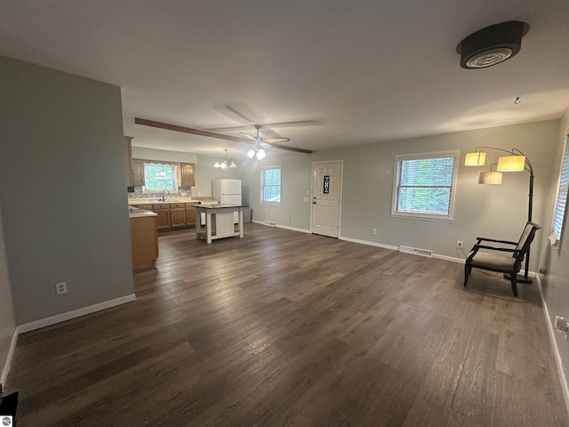 142 Forest Trl, Leroy, MI 49655 - unfurnished living room featuring a sink, dark wood-style flooring, baseboards, and ceiling fan
