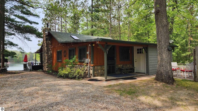 6875 Jose Lake Rd, South Branch, MI 48761 - view of front of house with stone siding and a chimney