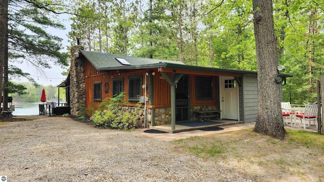 6875 Jose Lake Rd, South Branch, MI 48761 - view of front facade with a chimney and stone siding