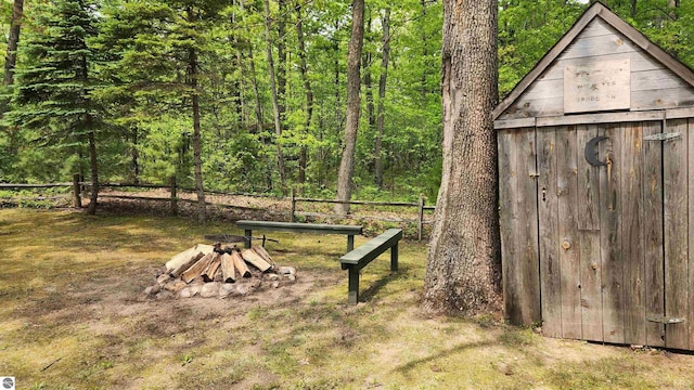 6875 Jose Lake Rd, South Branch, MI 48761 - view of yard featuring a fire pit and a forest view