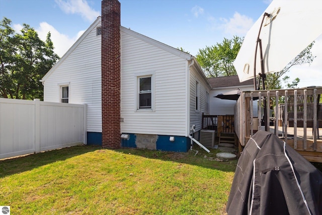 140 S State St, Alma, MI 48801 - view of side of home featuring a wooden deck, a chimney, and central AC