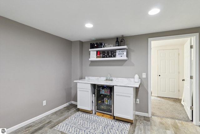 140 S State St, Alma, MI 48801 - indoor dry bar featuring beverage cooler, light wood-style floors, baseboards, and recessed lighting