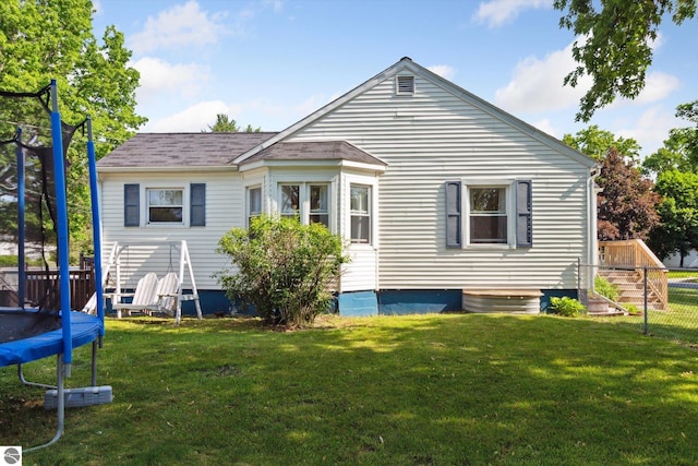140 S State St, Alma, MI 48801 - back of house featuring a trampoline and a yard