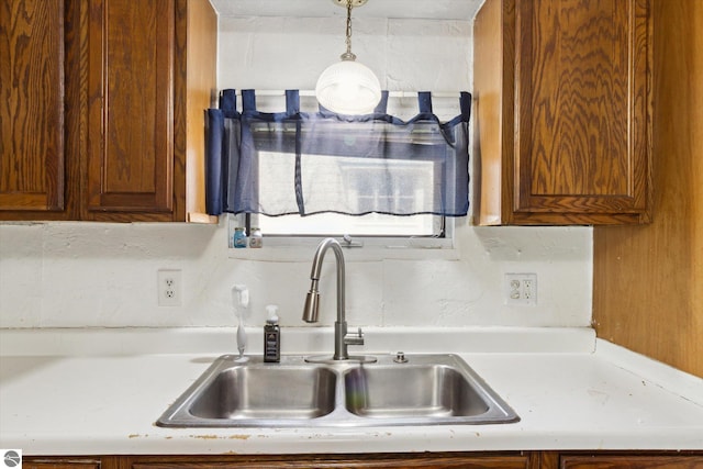 618 N River Ave, Alma, MI 48801 - kitchen with a sink, light countertops, and hanging light fixtures