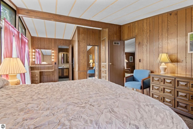 14501 Williams Dr, Elk Rapids, MI 49629 - bedroom with wood walls, carpet floors, ensuite bathroom, and lofted ceiling